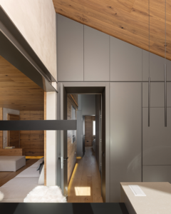 Porzione di tavolo e bancone cucina. Inoltre, parete attrezzata di accesso alla cucina, con finitura laccata opaca grigia, con porta integrata che dà accesso alla zona notte.